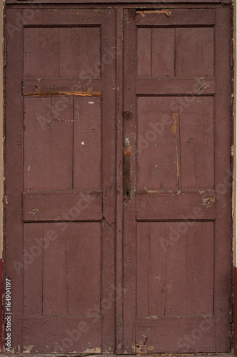 Locked and dirty wooden door.