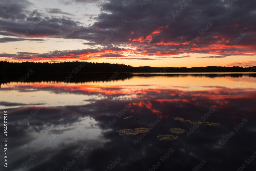 Beautiful sunsetting over a calm lake in sweden after a summers day