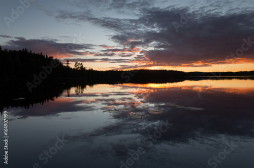 Beautiful sunsetting over a calm lake in sweden after a summers day © Henrik Larsson