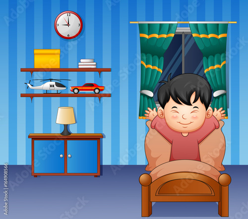Cartoon little boy waking up in a bed