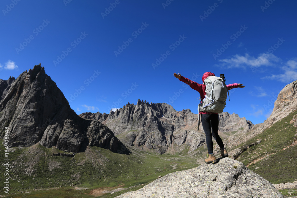 woman with backpack hiking in mountains travel lifestyle success concept adventure active vacations outdoor mountaineering sport  landscape