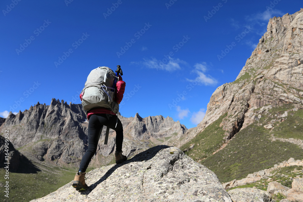 woman with backpack hiking in mountains travel lfestyle success concept