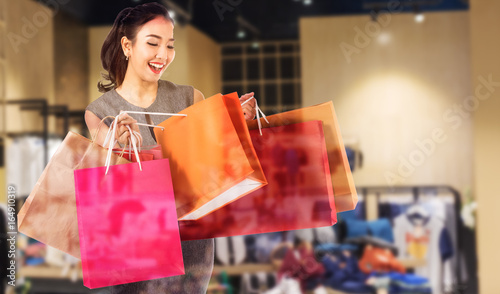 Double exposure women holding shopping bags in her hand with a copy space