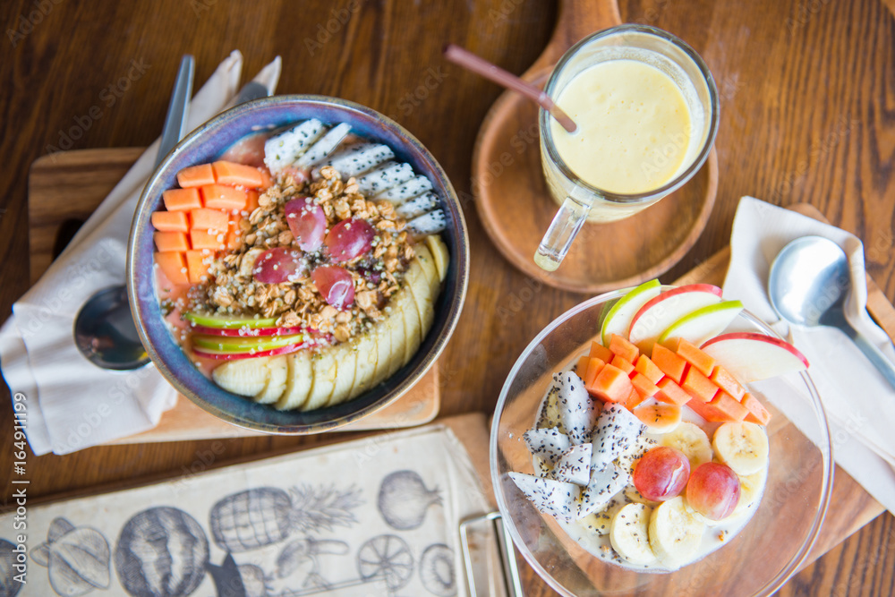 Healthy granola with fresh fruit and mango smoothie Healthy granola with fresh fruit and mango smoothie
