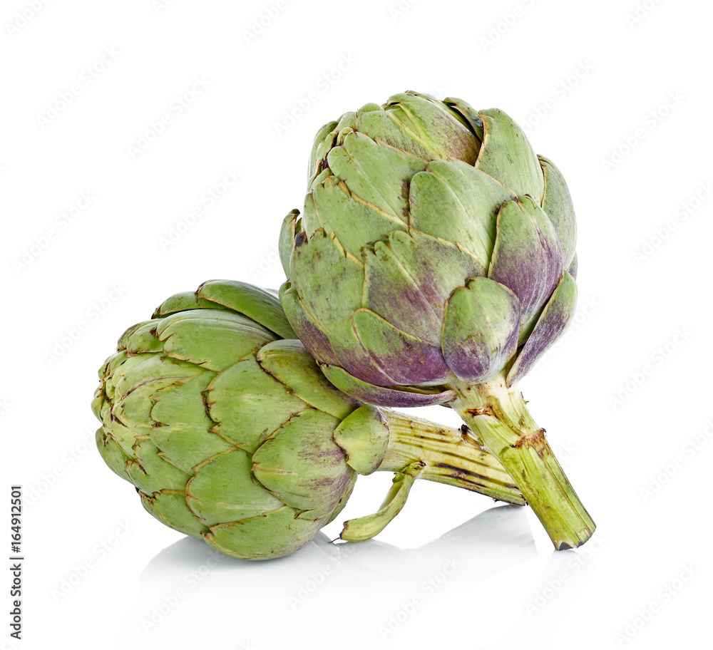 Obraz premium Two fresh artichokes with stem and leaf and a half showing the heart. Isolated.