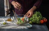 Man cooking vegetable salad home kitchen hand pouring lemon juice