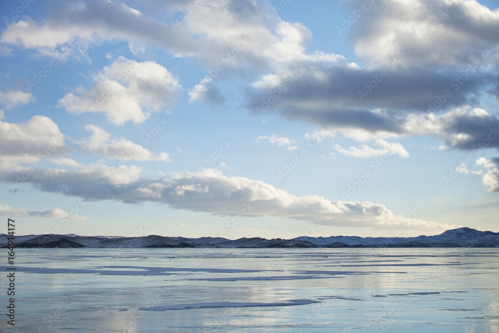 Lake Baikal ice. Mountain shore. Winter landscape