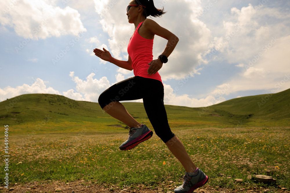 young fitness woman runner running on sunset grassland trail young fitness woman runner running on sunset grassland trail