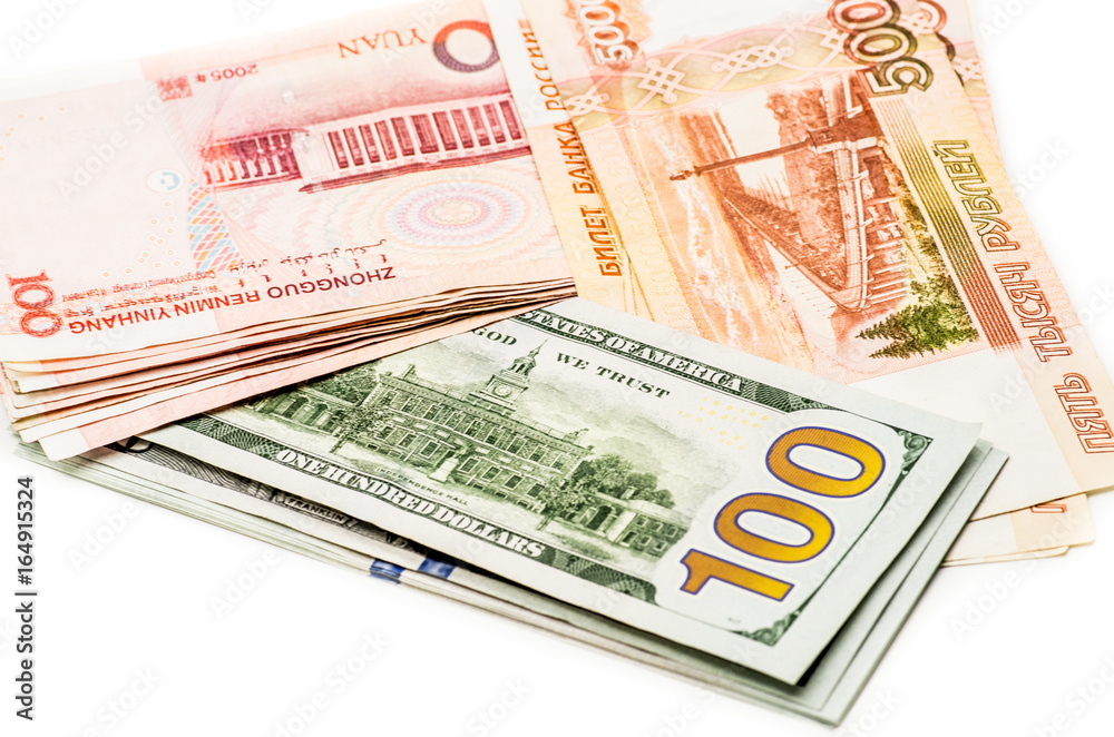 different currency banknotes. dollars, yuan and rubles on white different currency banknotes. dollars, yuan and rubles on white