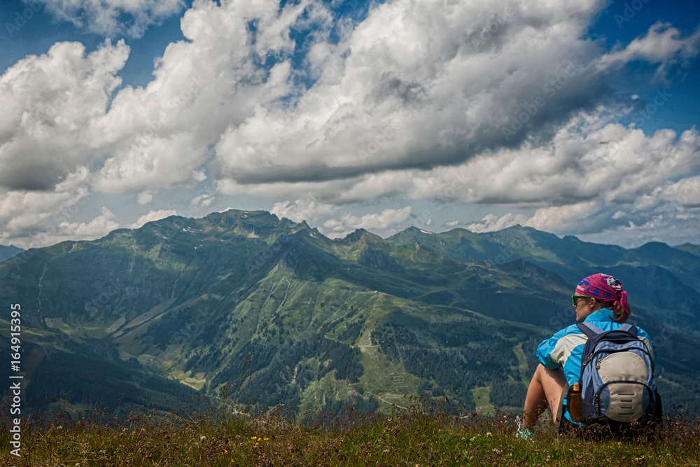 Young woman resting on a mountain hike in the Austrian Alps
