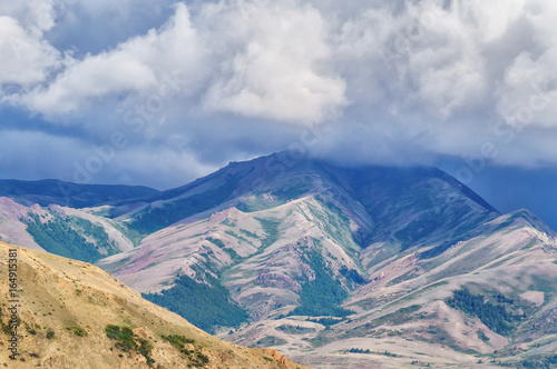 Big cloud lying on a hilltop in Altai