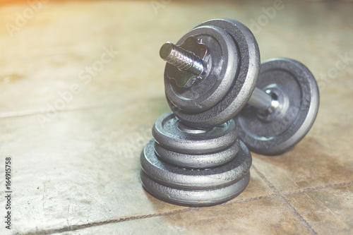 Iron Dumbbell on the floor with adjust iron weight plate.