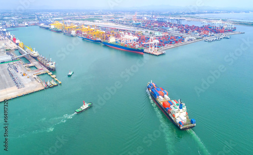 container ship in import export and business logistic.By crane ,Trade Port , Shipping,cargo to harbor.Aerial view.Water transport.International.Shell Marine.Top view.