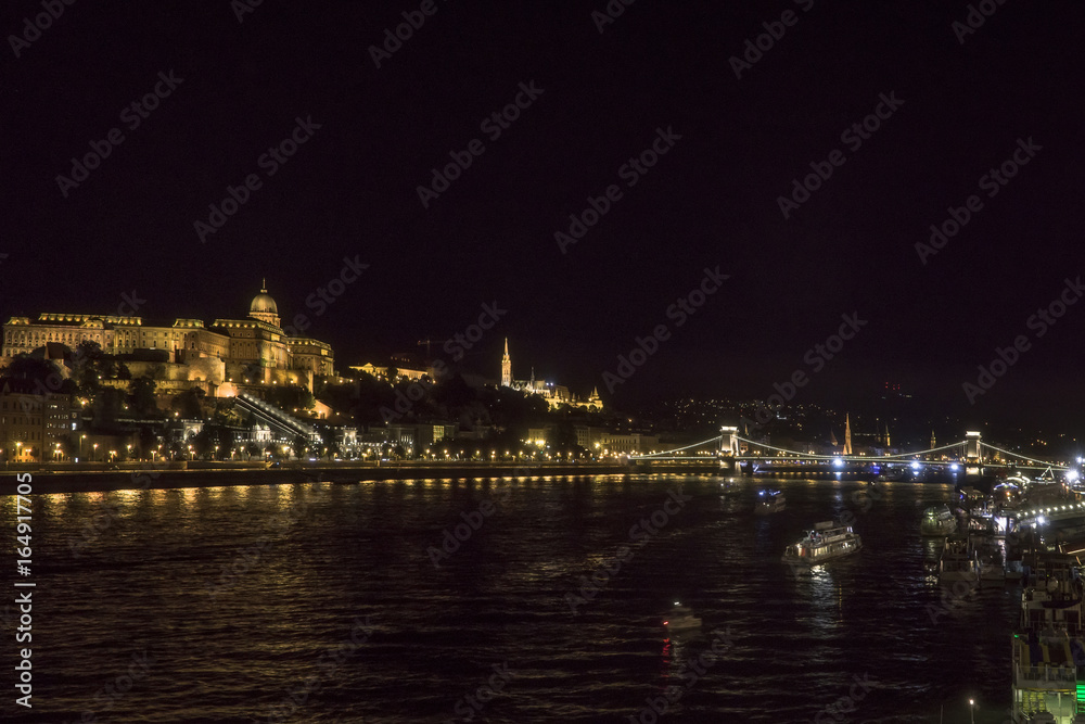 Night Budapest at the river Danube. Buda Castle (Royal Palace) and Chain bridge (Szechenyi lanchid) on background. Hungary