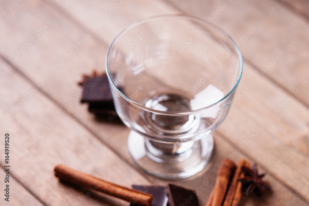 Anise and cinnamon sticks near empty glass Anise and cinnamon sticks near empty glass