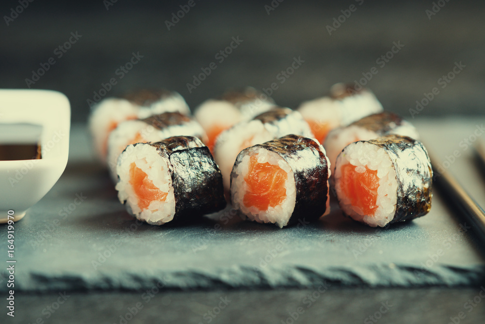 Sushi rolls with salmon, chopsticks and soy sauce Sushi rolls with salmon, chopsticks and soy sauce
