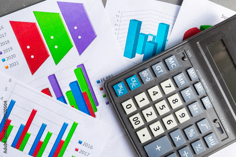 Checking accounting report on business table. Calculator Checking accounting report on business table. Calculator