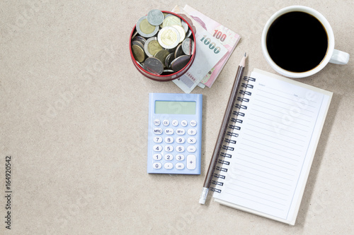 Copyspace of topview empyt page and coffee and pancil banknote and coin with cactus. photo