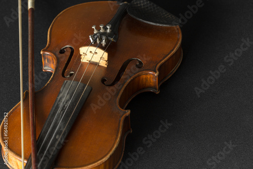 Old violin on a black background