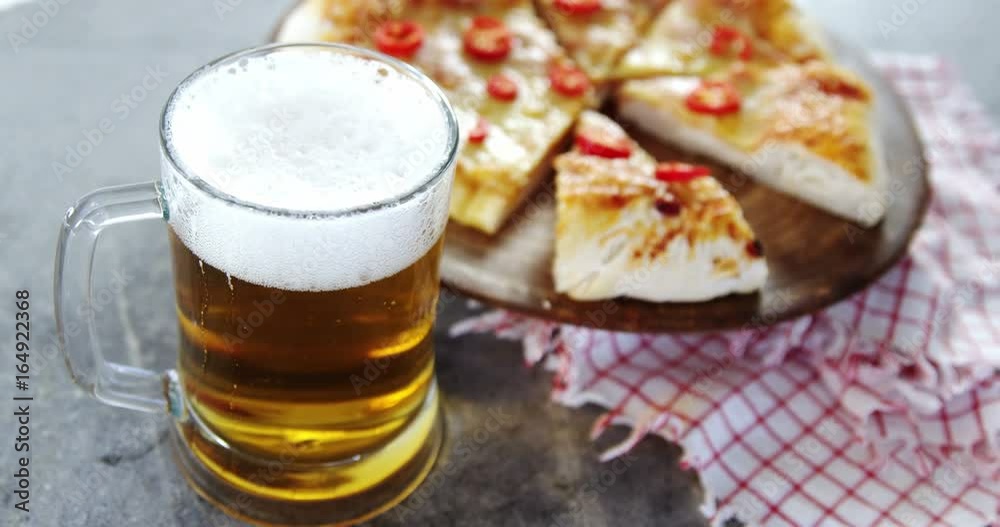 Delicious pizza with a glass of beer Delicious pizza with a glass of beer