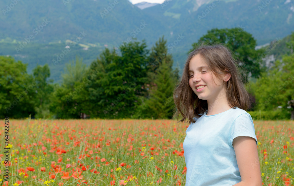 Young teenage girl in poppy field
