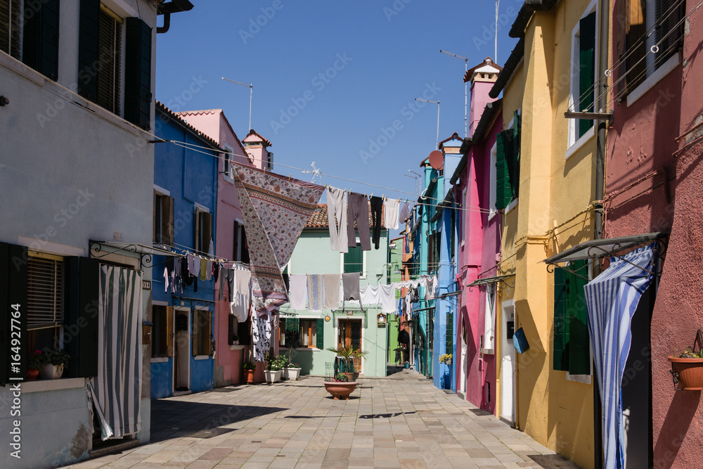 Clothes hanging between the houses of Burano - Venice - Italy