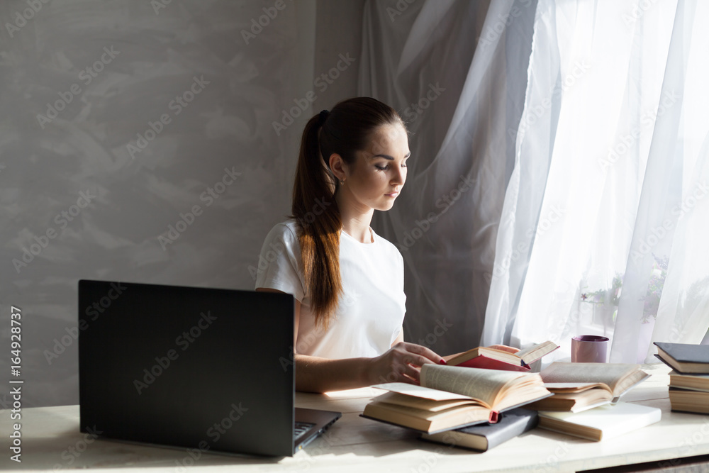 girl works at the computer reads books girl works at the computer reads books