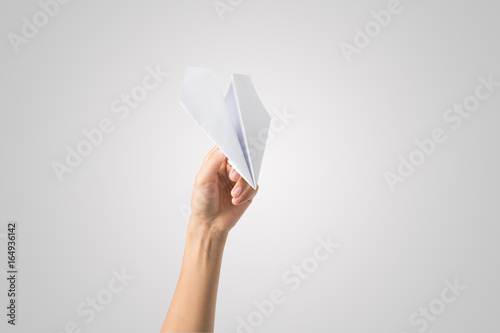 Woman hand Dart Paper Airplane isolated on white background.