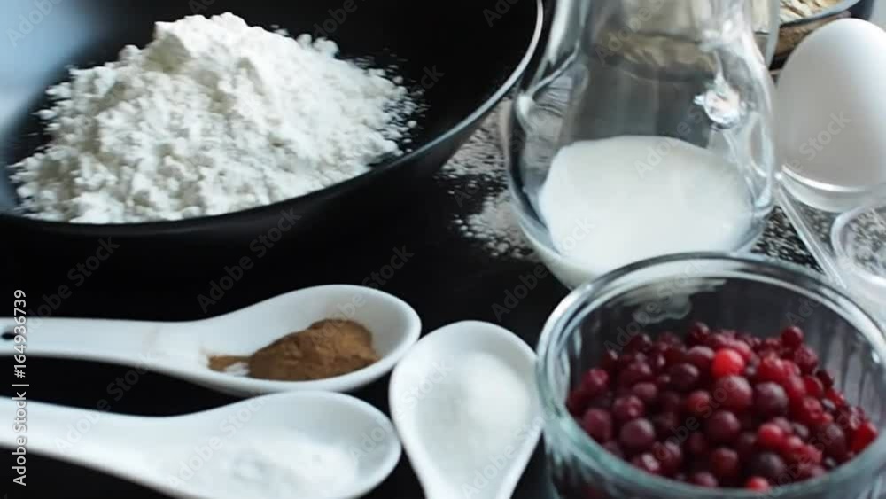 Cooking oatmeal cookies with cranberries. Ingredients for recipe, top view, flying camera
