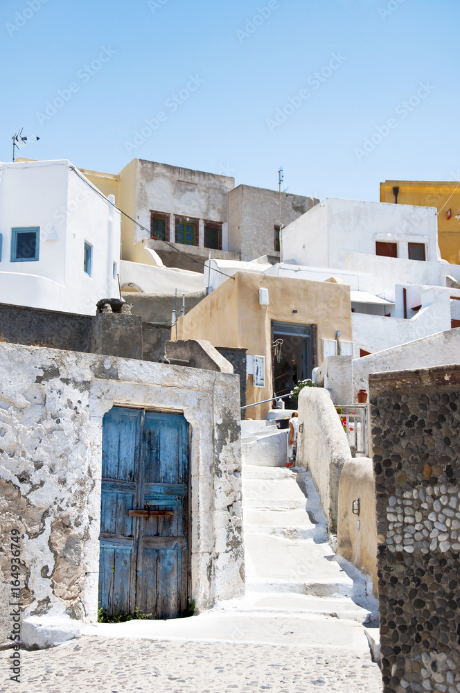 Traditional greek architecture with blue doors in the city of Pyrgos on the island of Santorini, Greece, Europe.