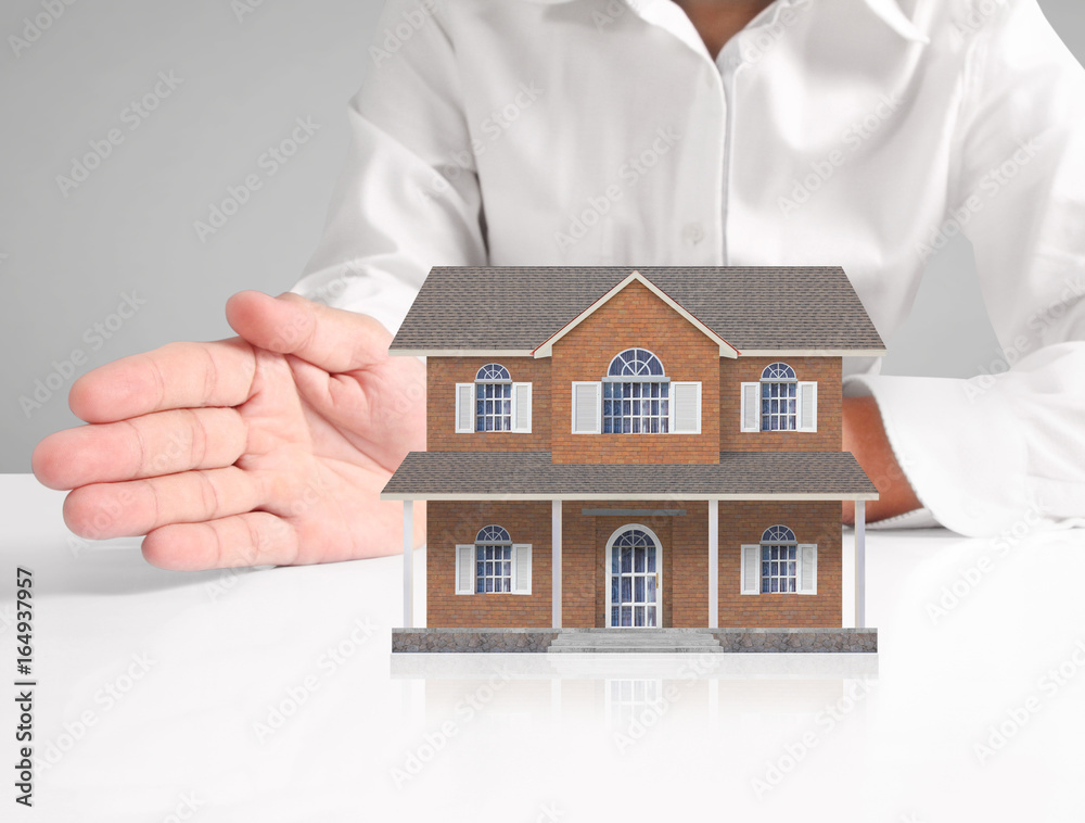 Mortgage concept by house from hand Mortgage concept by house from hand