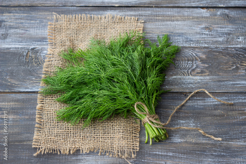 Fényképezés Bunch of fresh dill on a wooden surface with free space