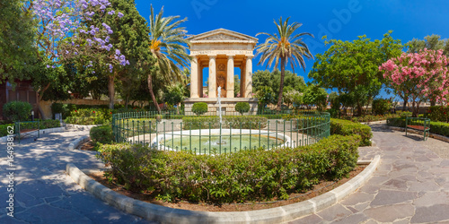 Panorama of blossoming spring Lower Barrakka Gardens and monument dedicated to Alexander Ball in the old town Valletta, capital of Malta. © Kavalenkava