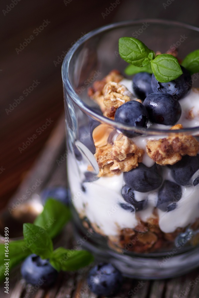 Glass with granola muesli, joghurt and blueberries Glass with granola muesli, joghurt and blueberries