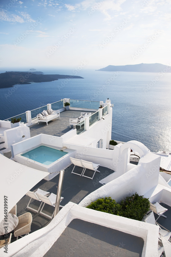 Santorini Island, Greece. Traditional Greek architecture, white houses, blue doors, the Aegean Sea.