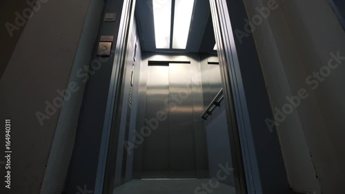 Elevator door opening and closing in a hallway