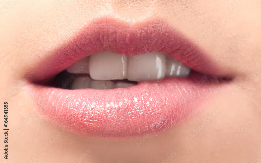 Fototapeta premium Young woman with natural lips makeup, closeup