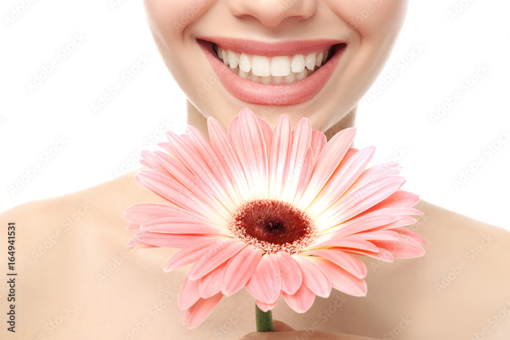 Closeup view of beautiful young woman with natural lips makeup and flower on white background Closeup view of beautiful young woman with natural lips makeup and flower on white background