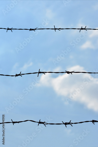 Barbed wire with a sky in the background