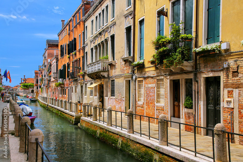 Row of houses along narrow canal in Venice, Italy