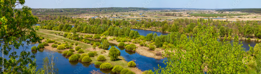 Springtime landscape banner, panorama - Desna river with flooded meadows and forests in Ukraine