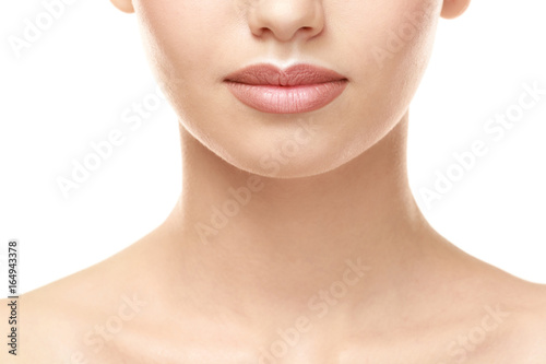 Woman with natural lips make up on white background, closeup