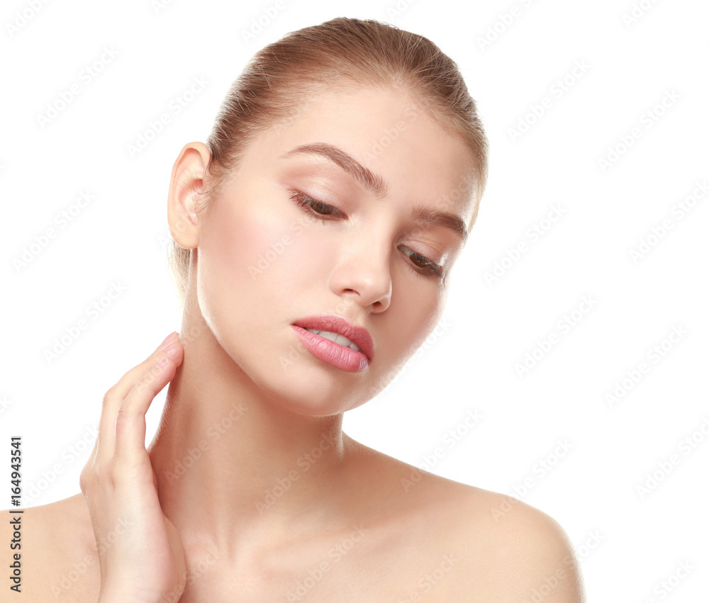 Closeup view of beautiful young woman with natural lips makeup touching neck on white background Closeup view of beautiful young woman with natural lips makeup touching neck on white background