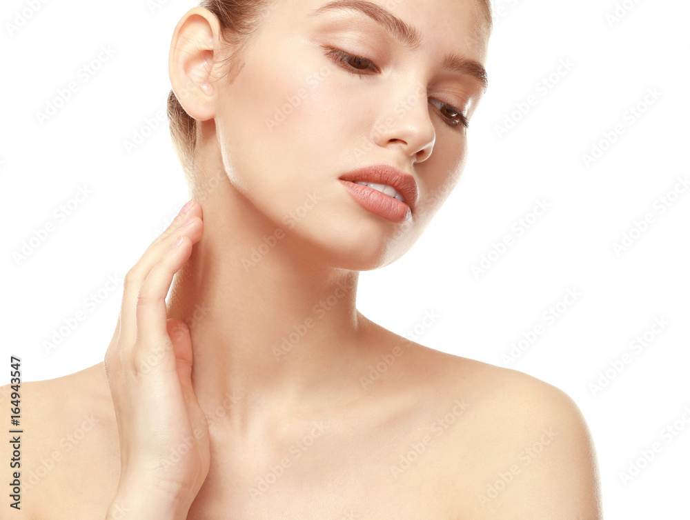 Closeup view of beautiful young woman with natural lips makeup touching neck on white background Closeup view of beautiful young woman with natural lips makeup touching neck on white background