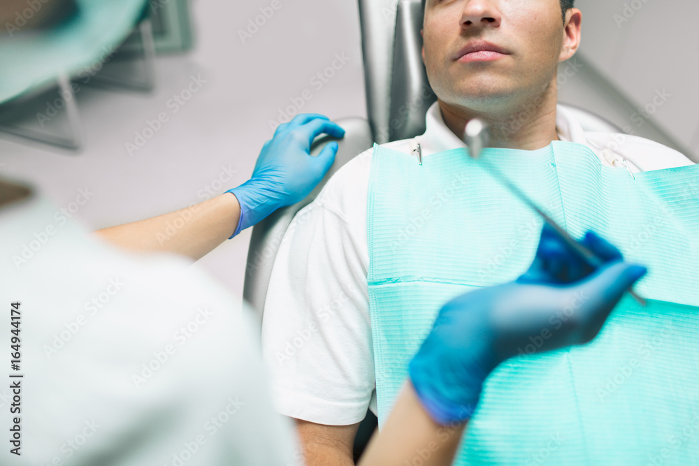 Portrait of a dentist who treats teeth of young man patient. Portrait of a dentist who treats teeth of young man patient.