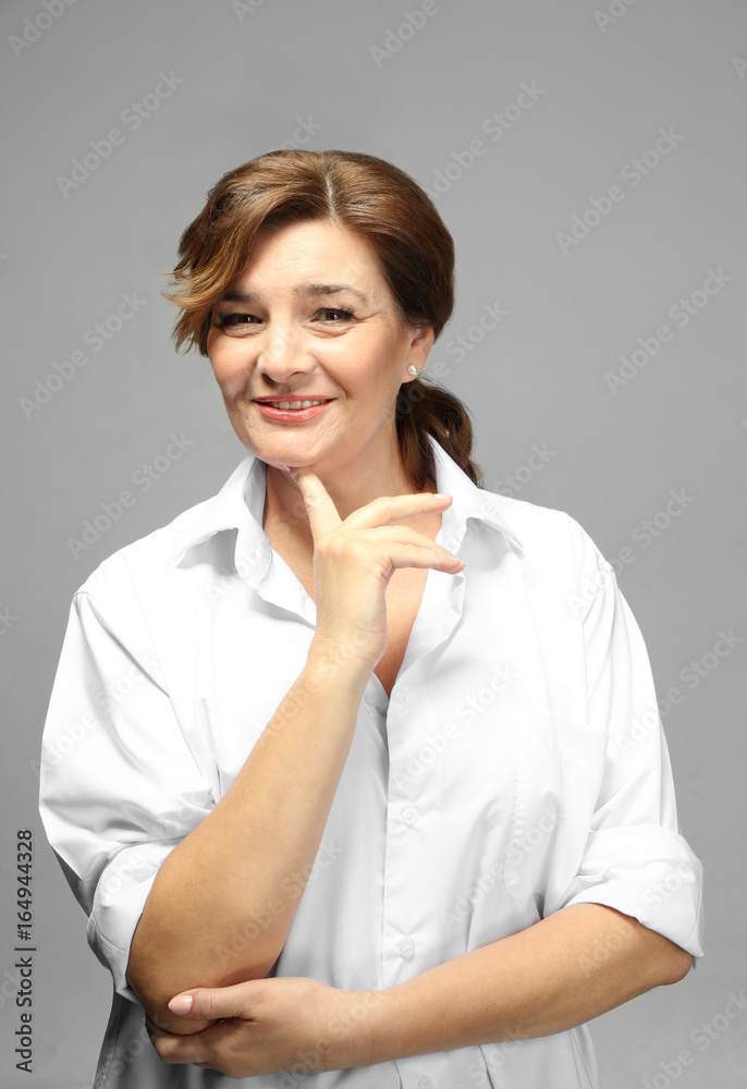 Beautiful elderly woman posing on light background Beautiful elderly woman posing on light background