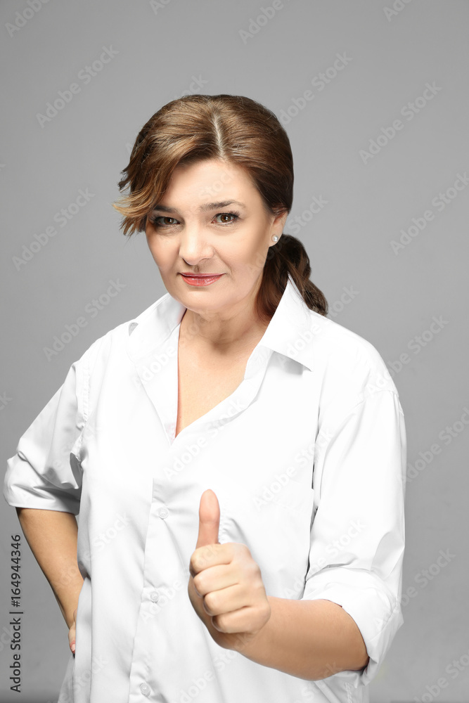 Beautiful elderly woman posing on light background Beautiful elderly woman posing on light background