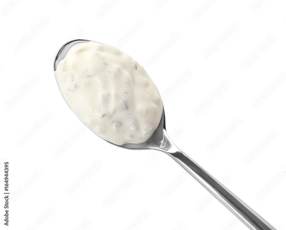 Delicious yogurt sauce in spoon isolated on white Delicious yogurt sauce in spoon isolated on white