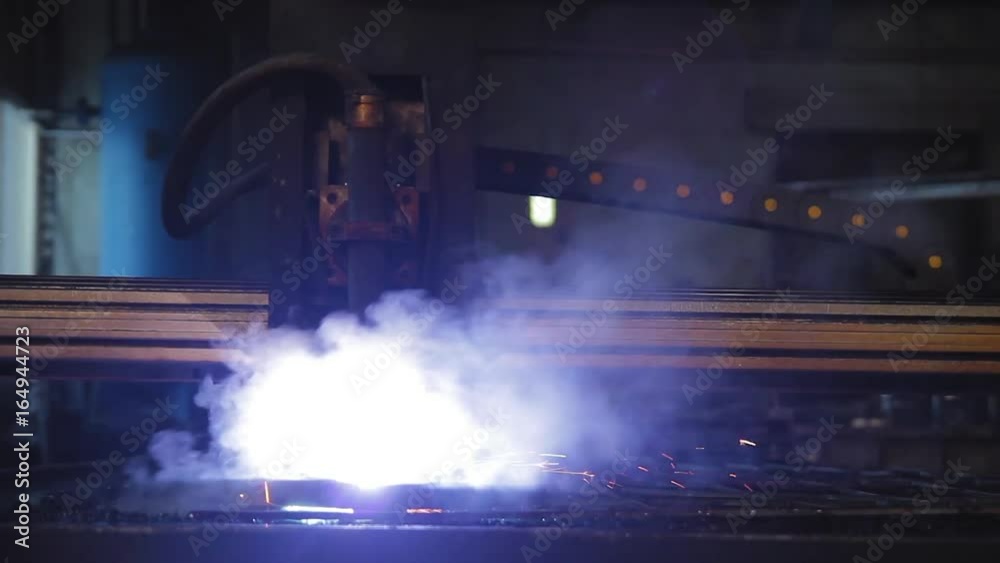 Plasma cutting at the factory, the machine cuts metal with caviar and bright light Plasma cutting at the factory, the machine cuts metal with caviar and bright light
