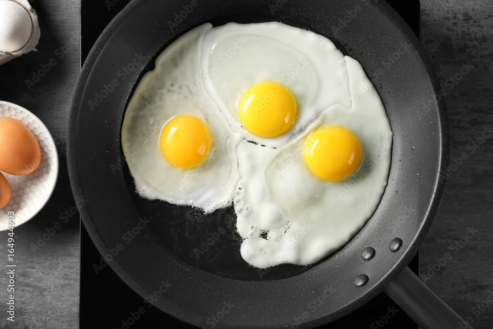 Delicious over easy eggs in pan on stove Delicious over easy eggs in pan on stove